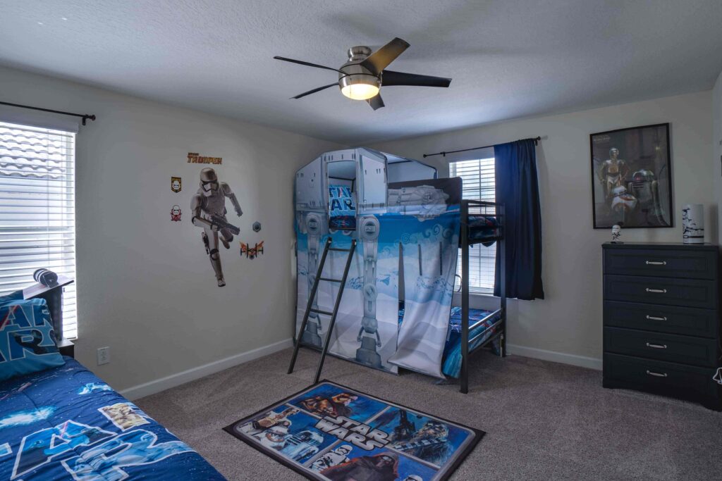 Champions Gate Magical Retreat upstairs kids star wars themed room with bunk bed, twin bed and trundle bed.