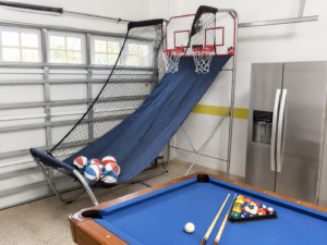Basketball game and blue pool table in the Rolling Skies game room