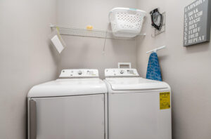 Champions Gate Epic Villa washer and dryer laundry room with iron and ironing board