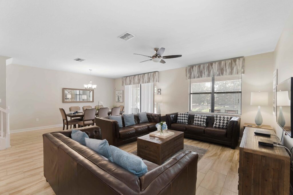 Champions Gate Rolling Skies downstairs family room with plenty of space to gather in couches and big screen smart tv