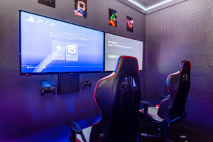 Champions Gate Epic Villa gaming center with xbox and playstation in gaming chairs