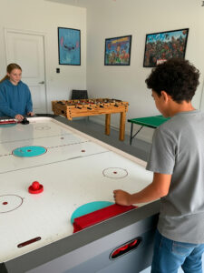 Champions Gate Magical Retreat garage game room with hockey, foosball and ping pong