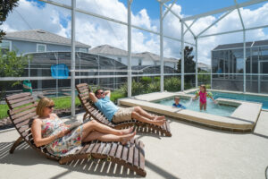 Champions Gate Magical Retreat pool and spa and lounge chairs in the screened in lanai
