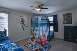 Champions Gate Magical Retreat upstairs kids star wars themed room with bunk bed, twin bed and trundle bed.