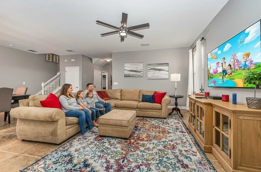 Champions Gate Epic Villa Main Level living room with large flat screen tv and sectional