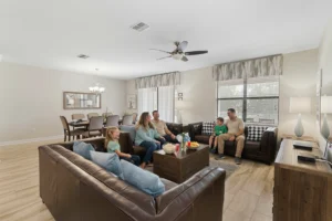 Family relaxing on sofas in the downstairs living room at Rolling Skies