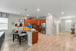 Guests gathered at the kitchen island near the entryway at Rolling Skies