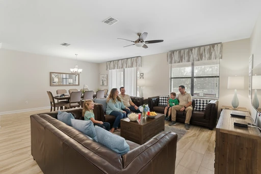 Champions Gate Rolling Skies downstairs family room with plenty of space to gather in couches and big screen smart tv
